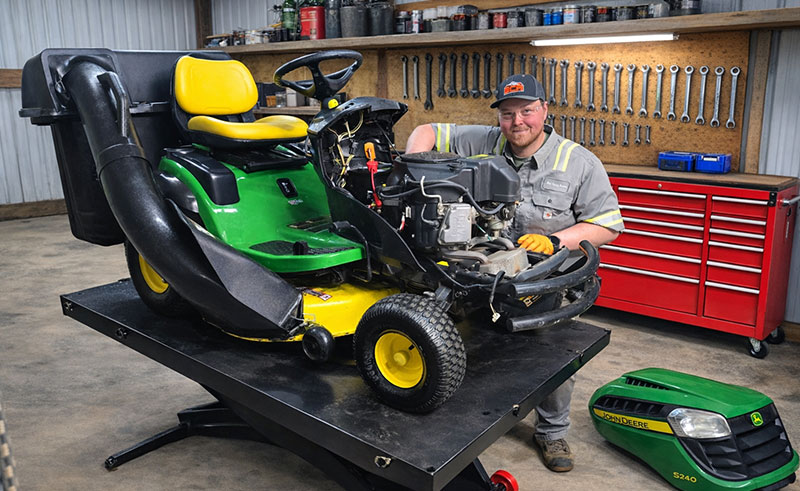 Technician fixing riding mower